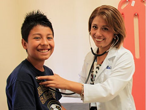 A boy gets a checkup at Children International’s medical clinic.