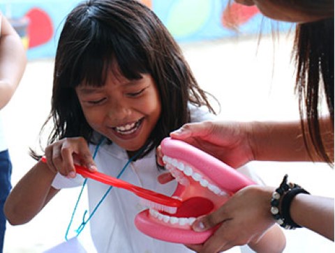 Children International teaches kids healthy behaviors, like the importance of brushing their teeth.