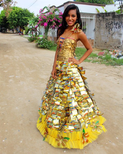 Teenage girl presenting a dress made of recycled disposable