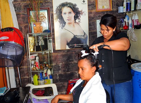 Former sponsored child provides hairstyling services at her beauty salon in the Dominican Republic.