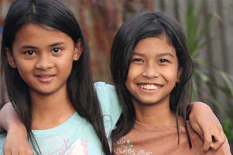 two young girls standing next to each other