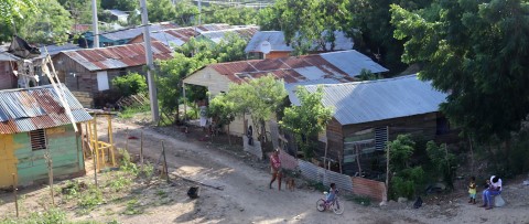 a group of people walking down a dirt road