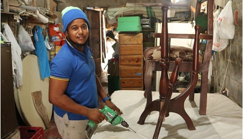 a man in a blue shirt and a blue hat