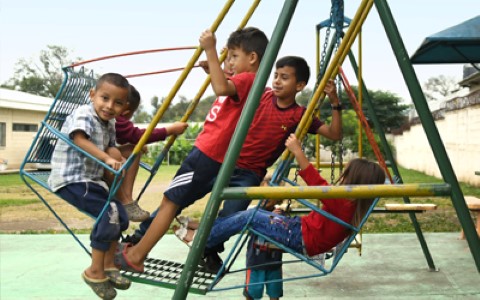 a group of children playing on a playground