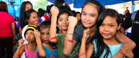 a group of young girls standing next to each other