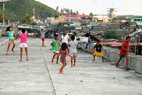 A group of kids play above a sewer in the Philippines