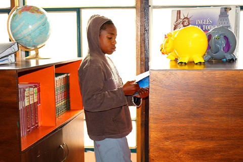 Ecuador boy reads book in CI community center library