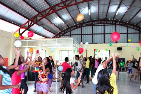 Teens play with balloons during a youth program activity 