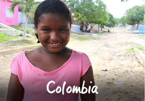 Colombia | a girl in a pink shirt smiles at the camera