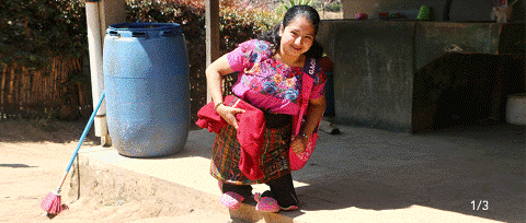 a woman in a pink shirt is standing on a sidewalk