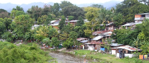 a river running through a lush green hillside