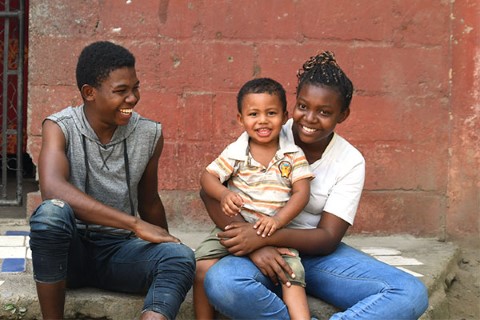 a woman and two children sitting on a step