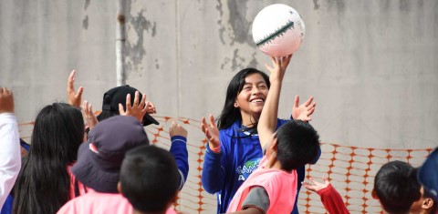 a group of children playing with a soccer ball