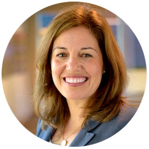 a woman with long hair and a blue blazer