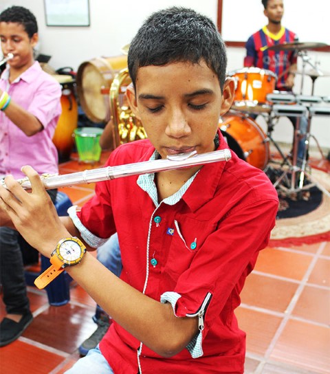 A boy practices the flute.