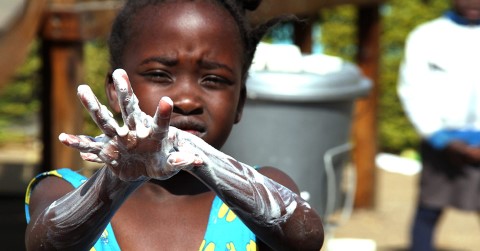 a little girl washing her hands