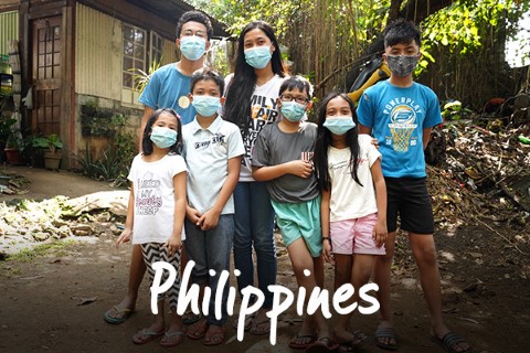 Philippines | a family standing infront of their home