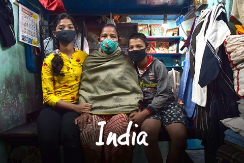 India | a group of people sitting on a bench in a room