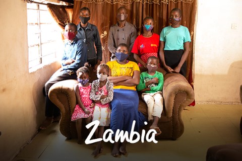 Zambia | un grupo de personas sentadas encima de un sofá