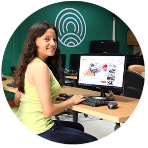 a woman sitting at a desk in front of a computer