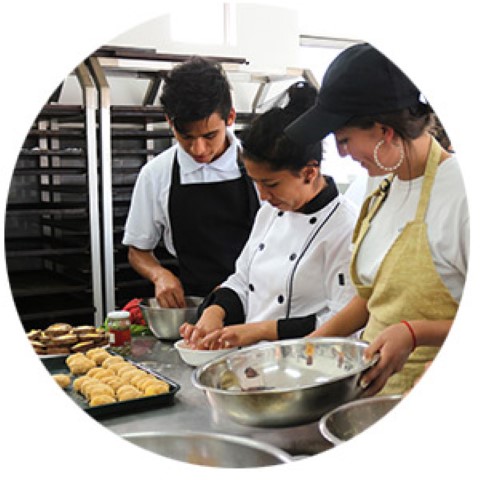 a group of people in a kitchen preparing food