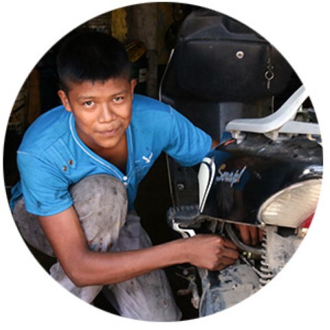 a man working on a motorcycle in a garage