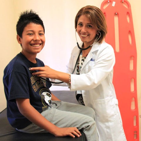 a woman in a white lab coat and a boy in a blue shirt