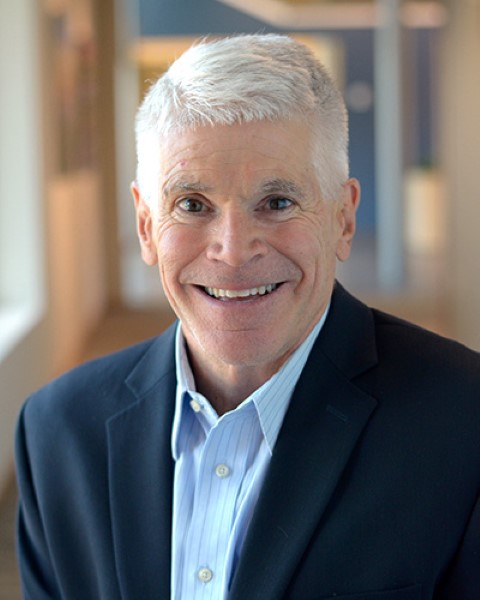 a man in a blue jacket and light blue shirt