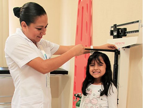 A young girl visits Children International’s medical clinic for a regular checkup.