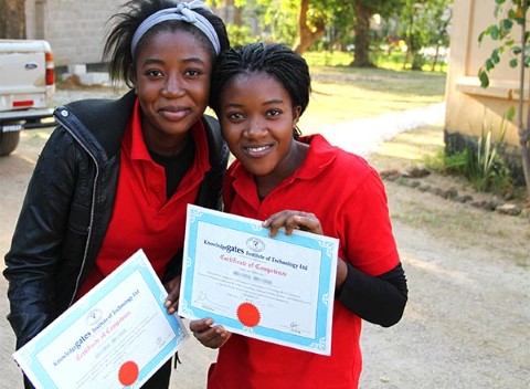 Sisters display their certificates in computing