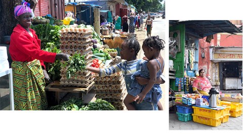 a group of people standing around a vegetable stand