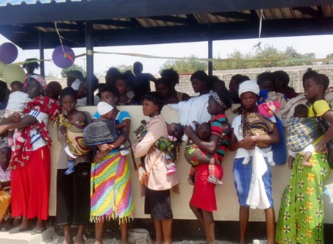 Lusaka mothers wait their turn at a health clinic under a shelter built by the CI Youth Council