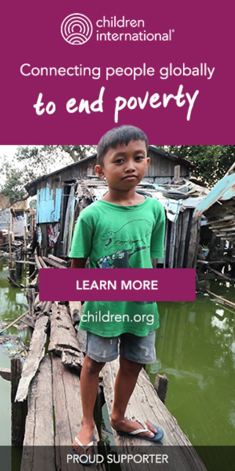 a young boy standing in front of water