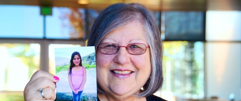 Sponsor and Team CI member Shirley Bowden holds up a picture of her sponsored child