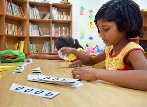 Girl works on activity in library