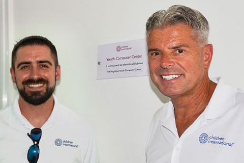 Dave Cormack and his son, Craig, stand in front of the new Youth Computer Center where teens can use computers to complete their assignments and do research on the internet.