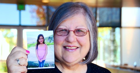 Sponsor and Team CI member Shirley Bowden holds up a picture of her sponsored child