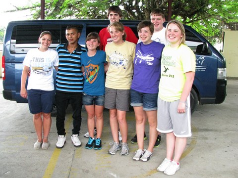 Mary's students pose with Edgar in front of the CI van.