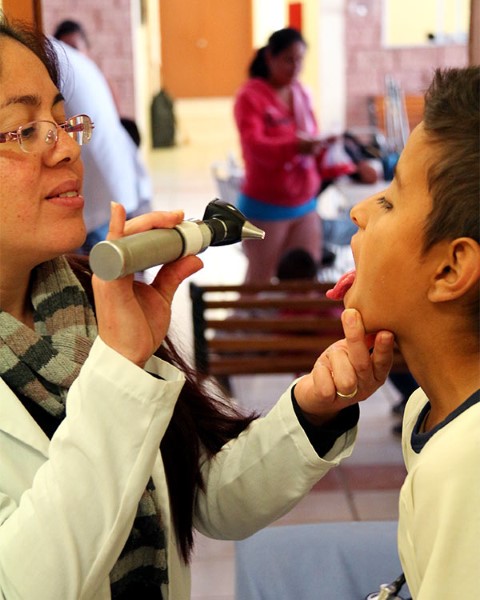 CI doctor Jessica Valdez exams a sponsored kid’s throat