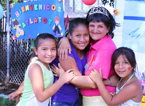A volunteer hugs sponsored kids at an event in Guayaquil, Ecuador. 