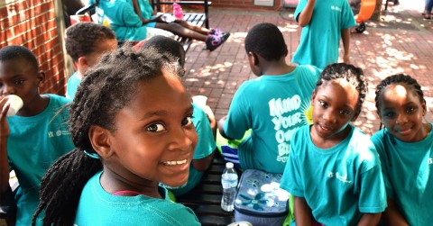 a group of children standing around each other