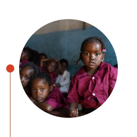 a group of children sitting in a classroom