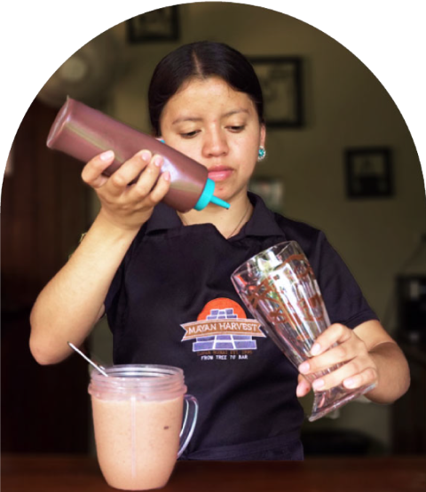 a woman is making an iced coffee