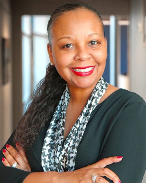 a woman in a black shirt and a scarf