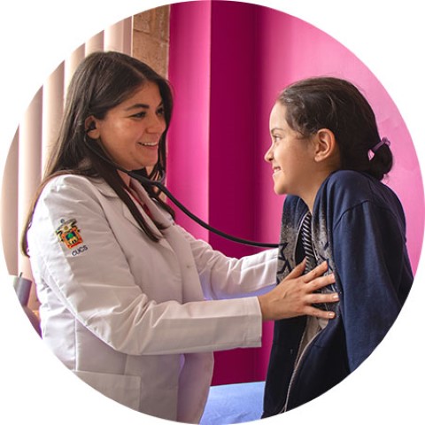 a woman is listening to a girl's heartbeat with a stethoscope