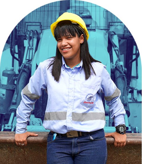 Young woman sits in front of heavy machinery