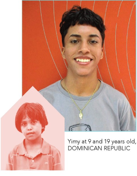 a young boy smiling to the camera