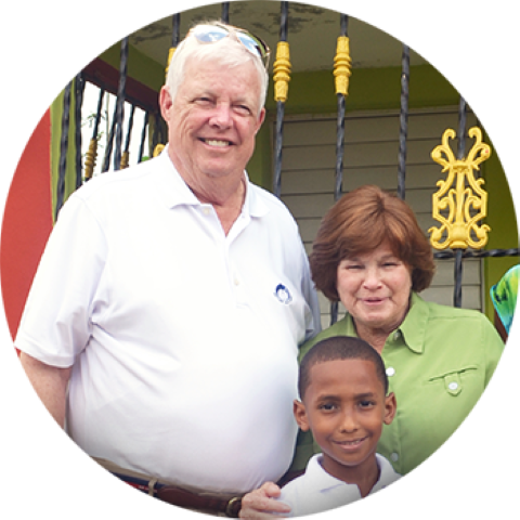 a man, woman and a child smiling to the camera