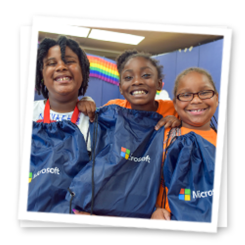 3 students smiling at the camera with backpacks