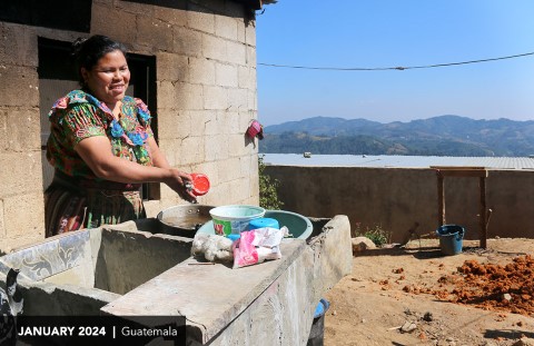 Woman handwashing clothes outside